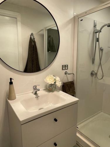 a bathroom with a sink and a mirror at Salty Kisses in Narrabeen