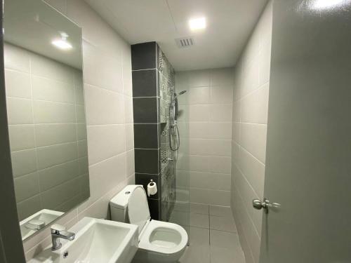 a bathroom with a toilet and a sink at Alinea BlueView Suites in Shah Alam