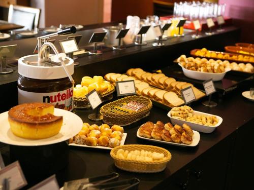 a buffet of different types of pastries and desserts at Mercure Sao Caetano do Sul in São Caetano do Sul