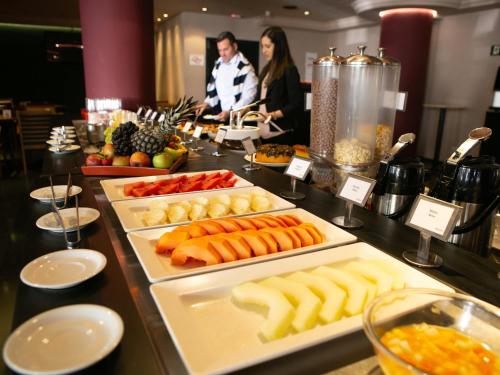 a buffet with many different types of food on display at Mercure Sao Caetano do Sul in São Caetano do Sul