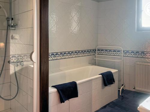 a bathroom with a bath tub and a shower at Gîte spacieux avec piscine et animaux admis à St Haon le Vieux - FR-1-496-156 in Saint-Haon-le-Vieux