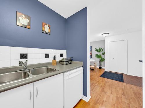 a kitchen with a sink and a counter top at Rare find by the Riverside in Windsor