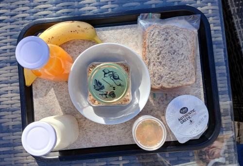 a lunch box with a banana and a plate of food at Alexandra Heights Motel in Alexandra