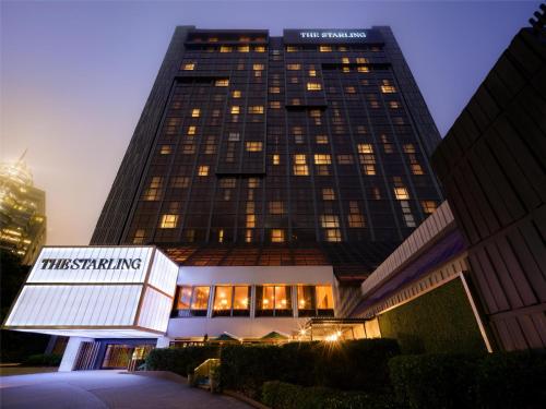 a tall building with a sign in front of it at The Starling Atlanta Midtown, Curio Collection by Hilton in Atlanta