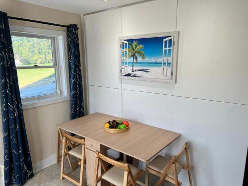 a dining room table with a bowl of fruit on it at Cozy & private apartment outside the city center in Hampstead