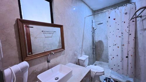a bathroom with a sink and a toilet and a shower at Critter Republic Dive Resort in Dauin