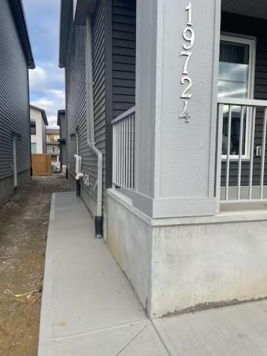 a building with a sign on the side of it at Bedroom in the basement Upland 2 in Edmonton