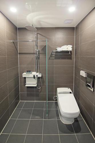 a bathroom with a toilet and a shower at Sokcho Doo Hotel in Sokcho
