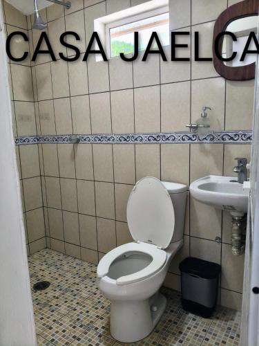 a bathroom with a toilet and a sink at spacious apartment with ocean view in Brisas de Zicatela
