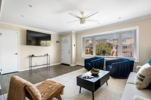 a living room with a couch and a table at Modern 3BR Near EWR, Parking, 25 Min NYC in Kearny