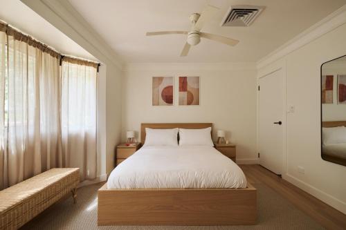 a bedroom with a bed and a ceiling fan at Maisonn Hinoki Spacious Holiday Oasis in Daleys Point