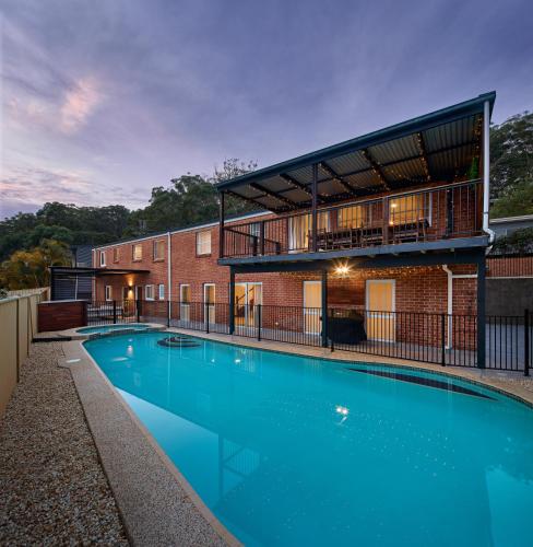 a large swimming pool in front of a building at Maisonn Hinoki Spacious Holiday Oasis in Daleys Point