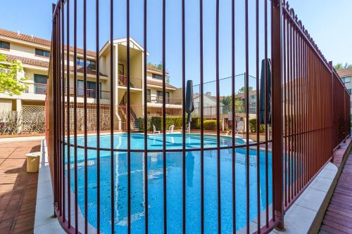 a fence around a swimming pool in a building at Quiet Retreat Close to City Centre and Lake - Hosted by Canstay in Canberra