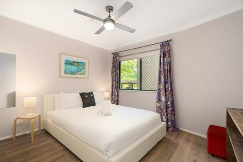 a bedroom with a white bed and a window at Quiet Retreat Close to City Centre and Lake - Hosted by Canstay in Canberra