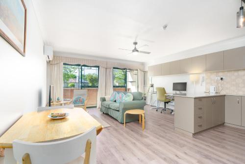 a kitchen and living room with a table and a couch at Quiet Retreat Close to City Centre and Lake - Hosted by Canstay in Canberra