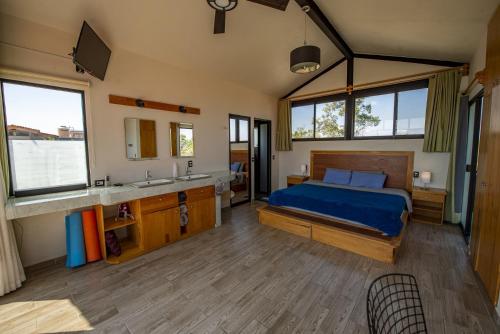 a bedroom with a bed and a sink and a mirror at Utopia Casas Boutique in Oaxaca City