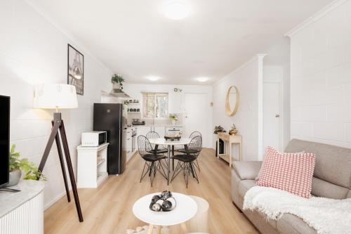 a living room with a couch and a table at Sunny Stay Near Flinders & CBD