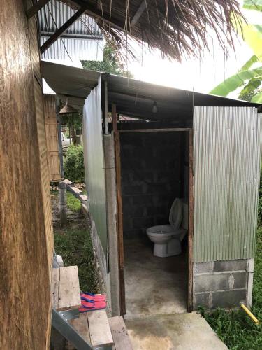 a toilet sitting inside of a building at Sparrow Hut in Pai