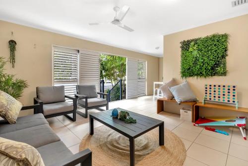 a living room with a couch and a table at Azure at The Edge, Steps to the Esplanade in Cairns North