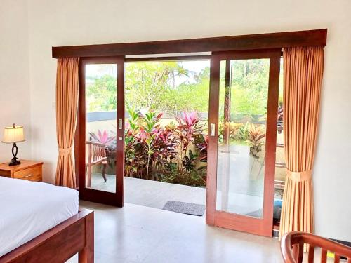 a bedroom with a bed and a sliding glass door at Luka's Place - 1 bedroom in Cemagi