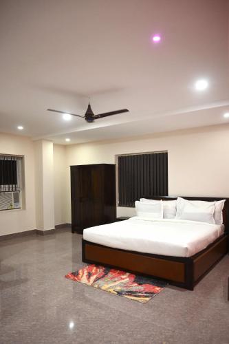 a bedroom with a large bed and a ceiling at Stanza Premium Hotels in Bhubaneshwar
