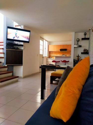 a living room with a couch and a flat screen tv at Bonita casa amueblada Cuautitlán in Cuautitlán