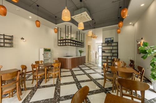 a restaurant with tables and chairs and a counter at Hygg Hotel Phu Quoc in Phu Quoc