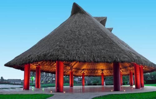a large pavilion with a thatched roof at Hotel Terranova in Coatzacoalcos
