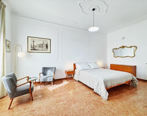 a bedroom with a bed and a desk and a chair at Merulana 13 in Rome