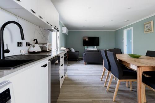 a kitchen with a wooden table and a dining room at Melrose Retreat with Court Access in Melrose