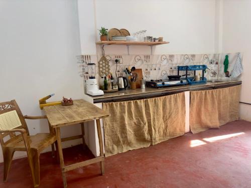 a kitchen with a table and a counter top at Stay Happy at Chathurni Villa, Ahangama in Ahangama
