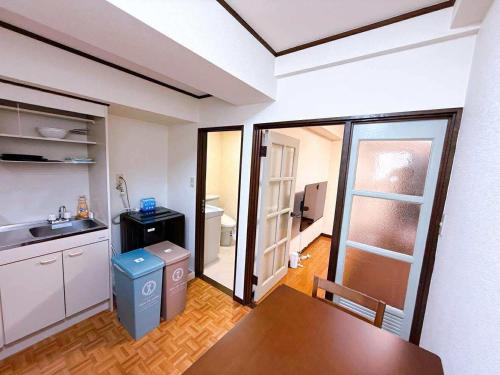 a kitchen with a table and a dining room at Stay Plus Sophia in Utsunomiya