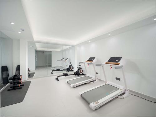 a gym with several treadmills and machines at Sanya Nature Reading · Fengbaijing Seaview Hotel in Yamamin