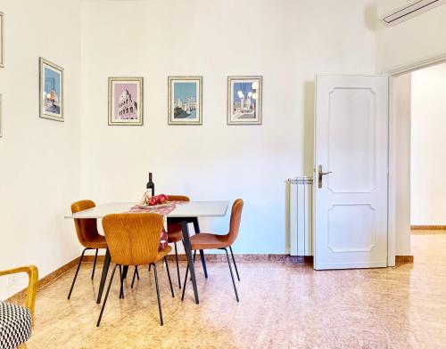 a dining room with a white table and chairs at Merulana 13 in Rome
