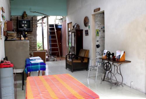 a living room with a table and a kitchen at Ximenas Guest House in San Salvador