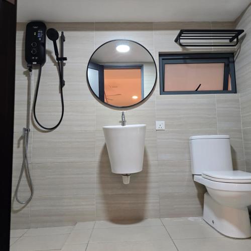 a bathroom with a shower and a mirror and a toilet at 3 Tower Ampang Suite in Kuala Lumpur