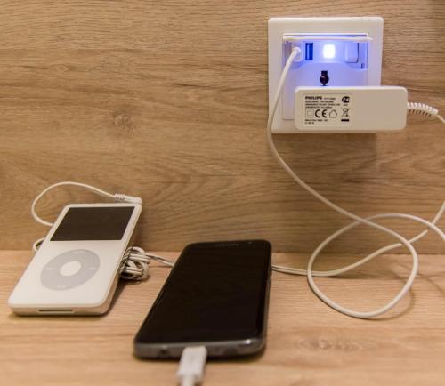an ipod and a cell phone hooked up to an charger at Mixx Ekpress Sunway in Petaling Jaya