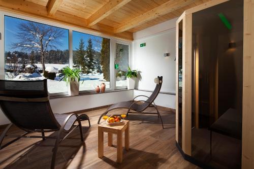 a living room with two chairs and a television at Ferienwohnungen Weiherbach - Hallenbad in Berchtesgaden