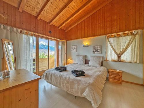 a bedroom with a bed with two bags on it at Alpine Balance - Sion and ski stay - Swiss Alp in Salins