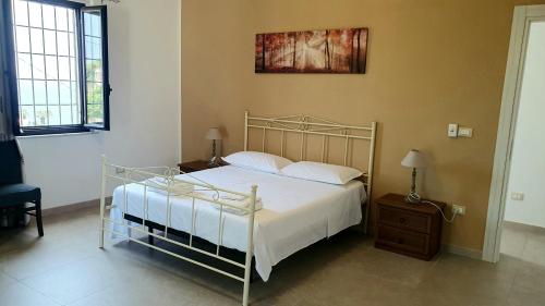 a bedroom with a bed with a metal frame at Appartamento - Plemmirio - Villa Maria Serena in Syracuse