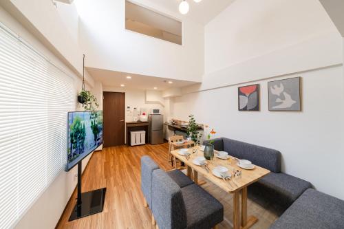 a living room with a table and chairs at KOTOBUKI House - Perfect for Groups - 3 Bedrooms, 3 Baths in Tokyo
