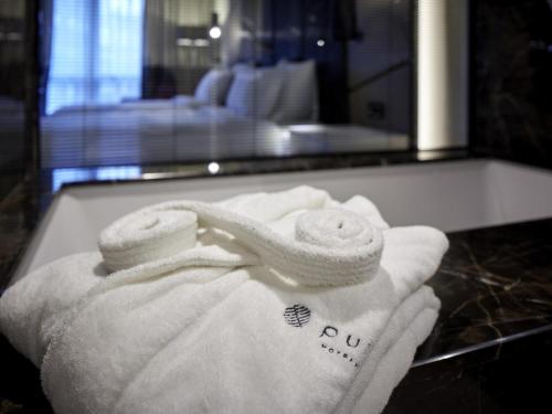 a pile of towels on a counter in a hotel room at Pullman Istanbul Hotel & Convention Center in Istanbul