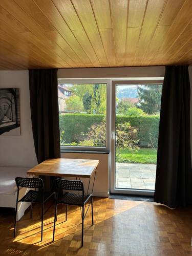a room with a table and chairs and a large window at Schwabenperle Apartments in Lauchheim