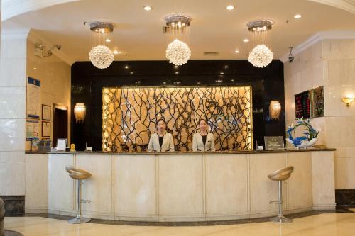 two women standing at a bar in a hotel lobby at Shenzhen Kaili Hotel, Guomao Shopping Mall in Shenzhen