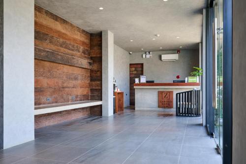 a hallway with wood accent walls and a counter at Z Garden Hotel Managed by H Hospitality in El Nido