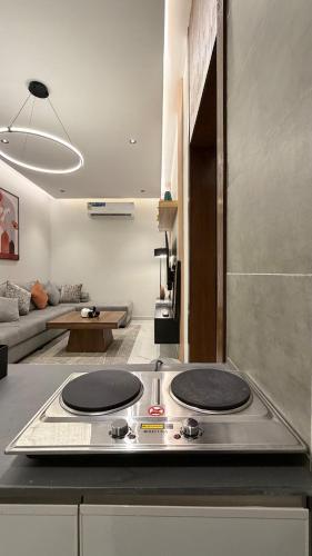 a kitchen with two burners on top of a stove at Luxury 2BR Apartment -Prime Area in Jeddah