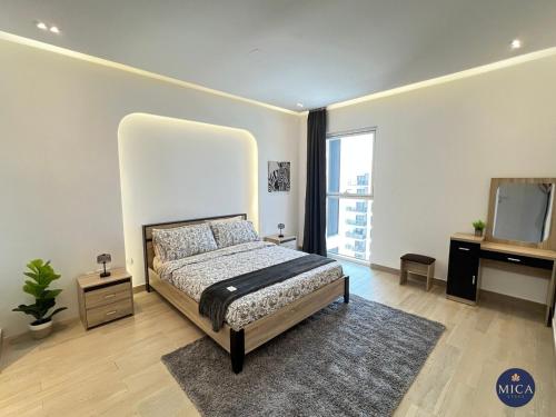 a bedroom with a large bed and a mirror at Spacious 2BR Yas island Pool, Gym, Parking in Abu Dhabi