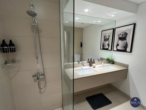 a bathroom with a sink and a shower at Spacious 2BR Yas island Pool, Gym, Parking in Abu Dhabi