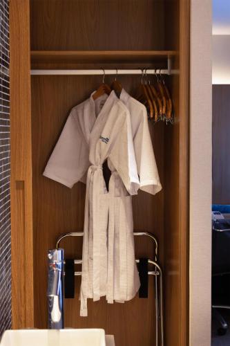 a group of white towels hanging on a rack at Radisson Blu São Paulo in São Paulo