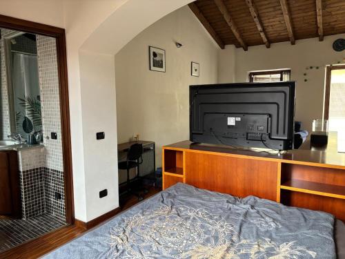 a bedroom with a bed and a large television at Cozy Apartment Near Lake Como, Sleeps for 4 in Maslianico